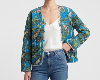 May include: A blue quilted jacket featuring a vibrant jungle print with cheetahs and palm leaves. The jacket has a V-neckline, long sleeves, two front patch pockets, and a grey and white striped trim along the edges with blue buttons.