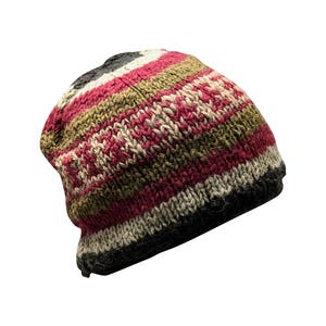 May include: A striped knit beanie hat with red, green, and white stripes. The hat is made of wool and has a slouchy fit.