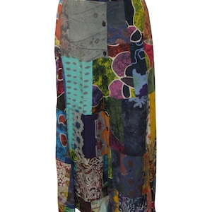 May include: A long, multi-colored patchwork skirt with a button closure. The skirt is made of various fabrics with floral and geometric patterns in shades of blue, green, red, purple, and yellow.