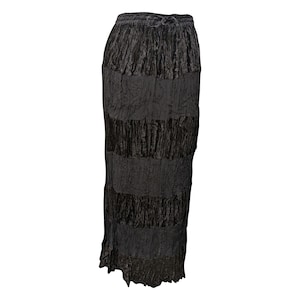 May include: A black velvet skirt with a tiered design. The skirt has a drawstring waistband and a ruffled hem.