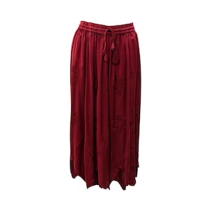 May include: A long, burgundy skirt with a drawstring waist and delicate embroidered details.