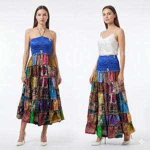 Puede incluir: Dos mujeres modelan faldas largas escalonadas. Las faldas presentan un diseño de patchwork vibrante con una cintura elástica azul. Una modelo lleva un top halter azul, la otra una camiseta sin mangas blanca. Ambas llevan tacones blancos.