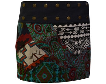 May include: A short, multi-colored skirt with a patchwork design featuring geometric and paisley patterns. The skirt has a dark blue waistband with decorative metal studs.