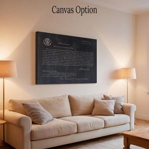 May include: A black and white canvas print of the Declaration of Independence with the text "When in the Course of human events..." and the date "July 4, 1776". The print is hanging on a wall in a living room with a couch and lamps.