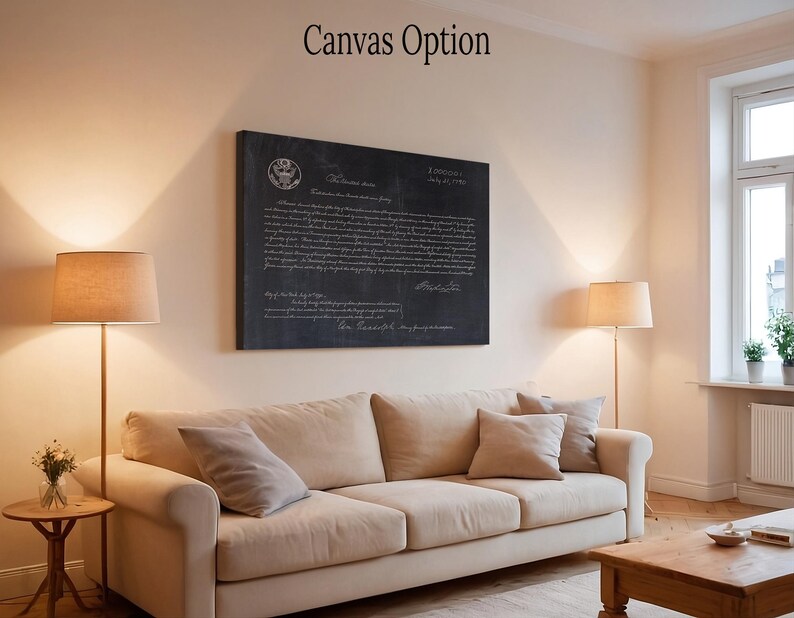 May include: A black and white canvas print of the Declaration of Independence with the text "When in the Course of human events..." and the date "July 4, 1776". The print is hanging on a wall in a living room with a couch and lamps.
