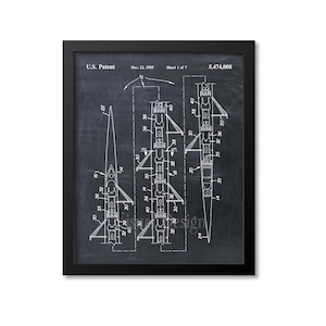 May include: A black and white illustration of a rowing shell patent drawing on a chalkboard background. The patent number is 5,474,008 and the date is 12 December 1995.