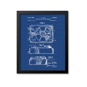 May include: A blue and white blueprint of a patent for a combination sound and picture mechanism. The patent number is 2,512,724 and was filed on November 1, 1949. The patent was granted on June 27, 1950 to Ralph M. Like.