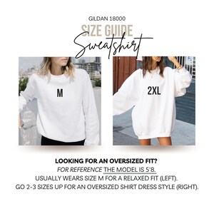 May include: Size guide for a Gildan 18000 sweatshirt. The image shows two models wearing white sweatshirts, one with an M and the other with a 2XL. Text reads: "Looking for an oversized fit? For reference the model is 5'8. Usually wears size M for a relaxed fit (left). Go 2-3 sizes up for an oversized shirt dress style (right)."