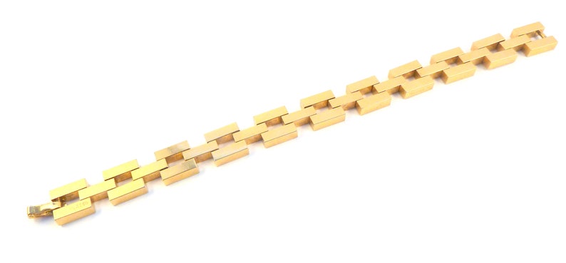 May include: A gold chain bracelet with a square link design.