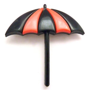 May include: A black and red plastic umbrella with a black handle. The umbrella is closed and has a simple design.
