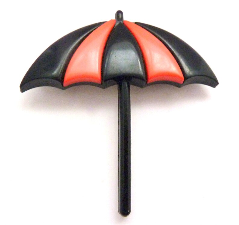 May include: A black and red plastic umbrella with a black handle. The umbrella is closed and has a simple design.