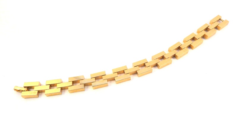 May include: A gold chain bracelet with a rectangular link design.