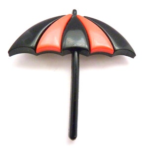 May include: A black and red plastic umbrella with a black handle. The umbrella is closed.