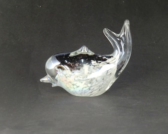 May include: A glass dolphin figurine with a clear body and black and white iridescent accents.