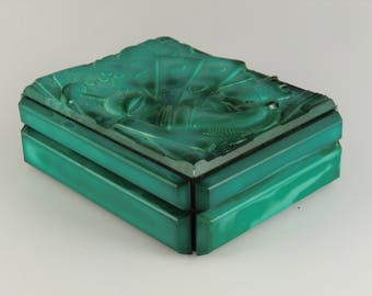 May include: A green rectangular box with a carved design on the top. The box is made of malachite.
