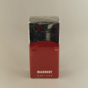 May include: A red and silver box with the text "WOMAN RED" and "MARBERT" on it. The box contains a 50 ml bottle of eau de toilette spray.