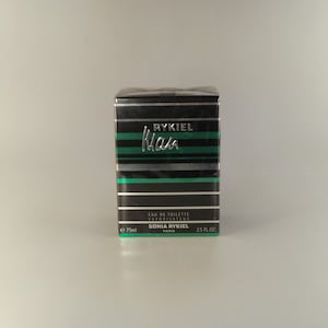 May include: A black and green striped box with the text "RYKIEL Man" in silver lettering. The box contains a bottle of Sonia Rykiel Eau de Toilette Vaporisateur, 75ml / 2.5 fl. oz.