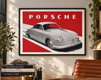May include: A framed wall art print featuring a silver vintage Porsche sports car on a red background with the word PORSCHE in white capital letters at the top. The car is depicted in a side-angled view, suggesting motion with white diagonal lines.