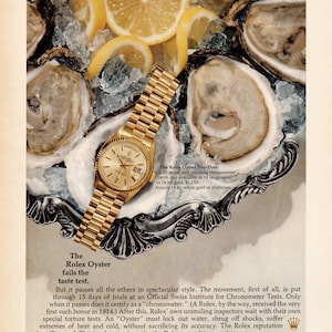 May include: A vintage advertisement featuring a gold Rolex Oyster Day-Date watch with a metallic link band resting on a silver platter filled with crushed ice and fresh lemon slices, surrounded by several raw oysters in their shells.