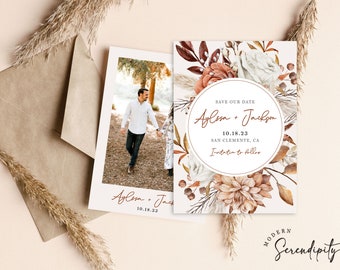 May include: Save the date wedding announcement with a watercolor floral design in shades of brown, white, and peach. The announcement features the text "Save Our Date" and the couple's names "Aylissa + Jackson" with the date "10.18.23" and location "San Clemente, CA".