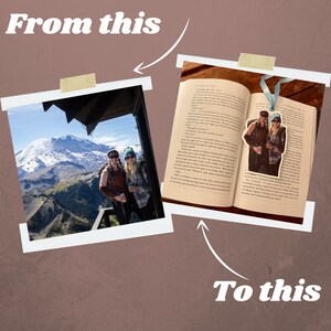 May include: A photo of a couple in front of a mountain is turned into a bookmark. The bookmark is placed in an open book. The bookmark is a light blue ribbon with a photo of the couple on it.