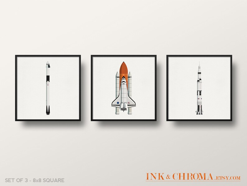 May include: Set of three 8x8 inch square prints featuring illustrations of different spacecrafts. The prints are in black frames and depict a white and black rocket, a white and orange space shuttle, and a white and black rocket.