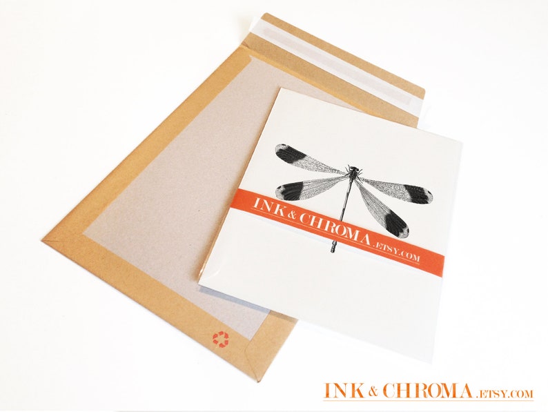 May include: A white envelope with a black and white dragonfly illustration and the text "INK & CHROMA. ETSY.COM" in red.