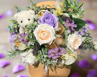 An artificial lilac coloured flower arrangement in gold hat box - personalised