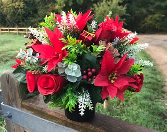 A Christmas memorial flower arrangement in black pot