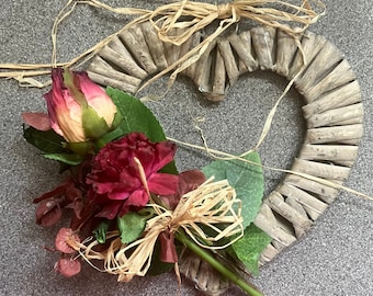 A Rustic Heart Shaped Wreath Decorated With Dried Flowers