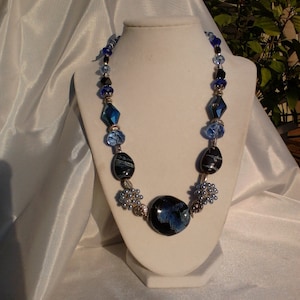 Blue and Black beaded statement necklace with glass and metal accent beads.