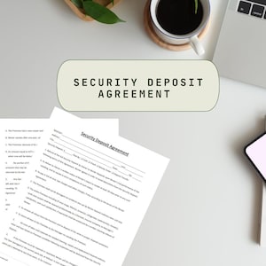 May include: A white and black security deposit agreement form with the title "Security Deposit Agreement" printed in bold black text. The form includes sections for tenant information, security deposit amount, and details about the agreement.