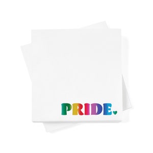 May include: A stack of white sticky notes with the word "PRIDE" written in rainbow colors with a small heart at the end.