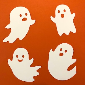 May include: Four white paper ghost cutouts on an orange background. The ghosts have different facial expressions.