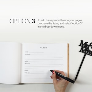 May include: A white guest book with a brown cover, open to a page with the word "GUESTS" printed at the top. The page has lines for guests to write their names and messages. A hand is writing in the book with a black marker. A black "Mr. & Mrs." sign is in the top right corner of the image.