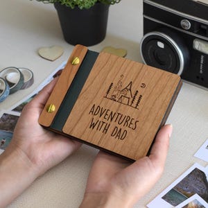 Handcrafted Mini Keepsake polaroid Photo Book With A Wooden Cover And Customizable Engraving, Perfect For Father's Day. This Unique Gift For Dad Features The Message adventures with dad And Is An Ideal Father's Day Gift For Him.