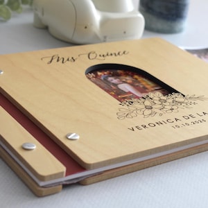Customizable quinceañera guest book with a photo insert and engraved floral design on the cover. This wooden guest book is perfect for capturing memories and messages from friends and family during the celebration. Fully customizable photo and text.