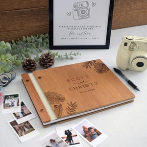Custom wedding guest book engraved tropical leaf design. Fully customizable, it’s perfect for capturing special memories at weddings and significant events. for Polaroid photos, this guest book offers a unique and personalized keepsake.