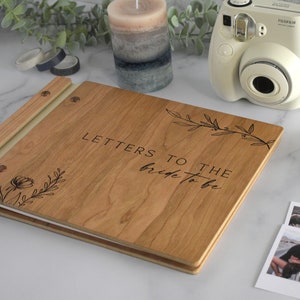 Minimalist letters to the bride guest book in cherry wood finish with engraved, customized and a boho leaf design on the cover.