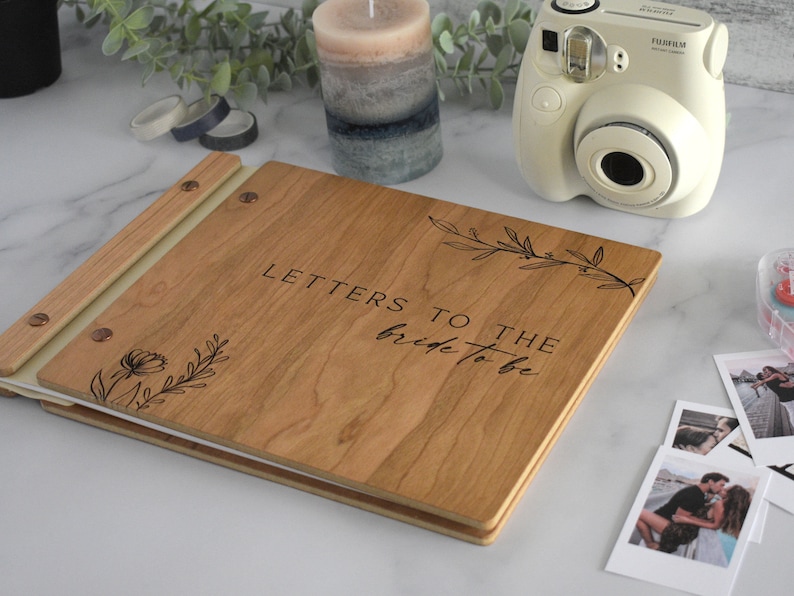 Minimalist letters to the bride guest book in cherry wood finish with engraved, customized and a boho leaf design on the cover.