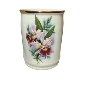 May include: A set of three ceramic mugs with a speckled, matte finish. The mugs are in shades of cream, light grey, and dark grey. Each mug has a simple, minimalist design, ideal for coffee or tea.