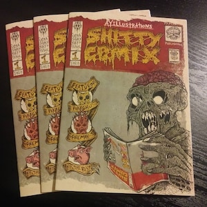 Könnte beinhalten: Drei Comic-Hefte mit einem roten, weißen und schwarzen Cover, auf dem ein zombieartiges Wesen zu sehen ist, das ein Comic-Heft liest. Der Text auf dem Cover lautet "AYILLUSTRATIONS SHITTY COMICS" und "EXTRA SHITY FIRST ISSUE 1 2020".