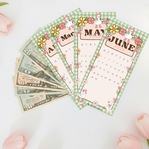 May include: A collection of calendar cards for March, May, and June 2026, featuring a green gingham border and floral and duck illustrations. The cards are fanned out next to a stack of U.S. currency. The text "By LUNA ALEIA" is visible.