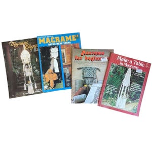 May include: A collection of four instructional craft books featuring macrame projects. The titles include Macrame Elegance, Easily Done Macrame Using New Fibers, Macrame for Beginners, and Make a Table in Macrame, each displaying various knotted designs.