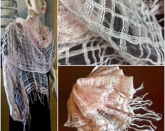 May include: A delicate pink and white crochet shawl with fringe. The shawl is made of a lightweight, airy fabric and has a delicate, feminine look.