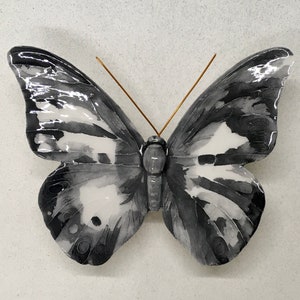 Ceramic butterfly made and decorated by hand. The colors are fantasy but the shape is of a real butterfly.