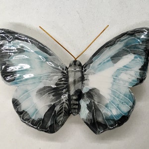 Ceramic butterfly made and decorated by hand. The colors are fantasy but the shape is of a real butterfly.