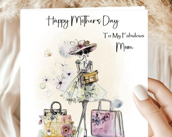 May include: A greeting card with the text "Happy Mothers Day To My Fabulous Mum". The card features an illustration of a woman in a floral dress, sunglasses, and a hat, with handbags and flowers.