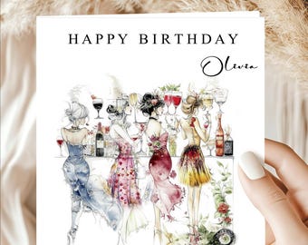 May include: A birthday card with the text "HAPPY BIRTHDAY Olivia" features an illustration of women at a bar. The women are dressed in colorful dresses and holding glasses of wine. The card has a white background.