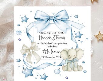 May include: A baby announcement card featuring a blue ribbon design and an elephant illustration. The card says "CONGRATULATIONS Hannah & Thomas on the birth of your precious baby boy Arlo James 25th December 2025."